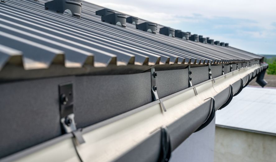 Seamless metal gutter and guard installation